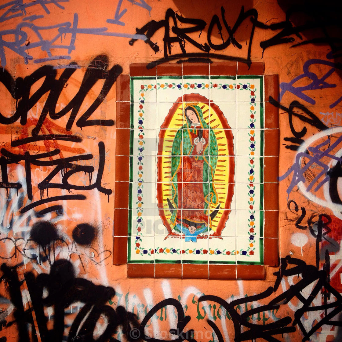 Graffiti surrounds the Virgin of Guadalupe in Colonia Portales